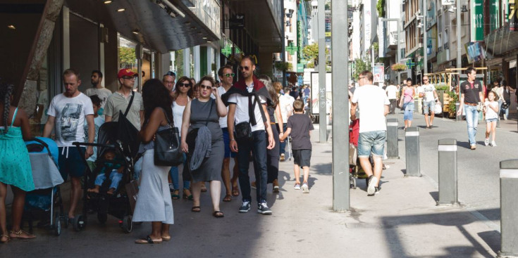 Unes persones passegen per l’avinguda Meritxell.