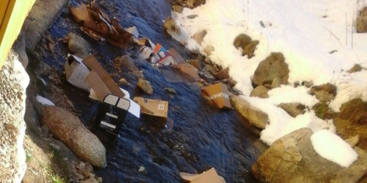 Una imatge del riu Arieja ple de capses de cartró i d’escombraries, aquest dissabte passat.