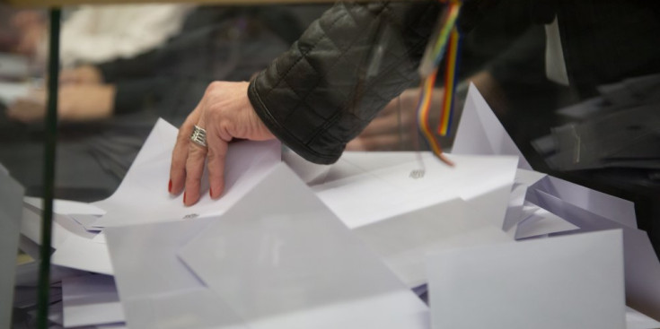 Una dona inicia el recompte de vots posterior a una votació.