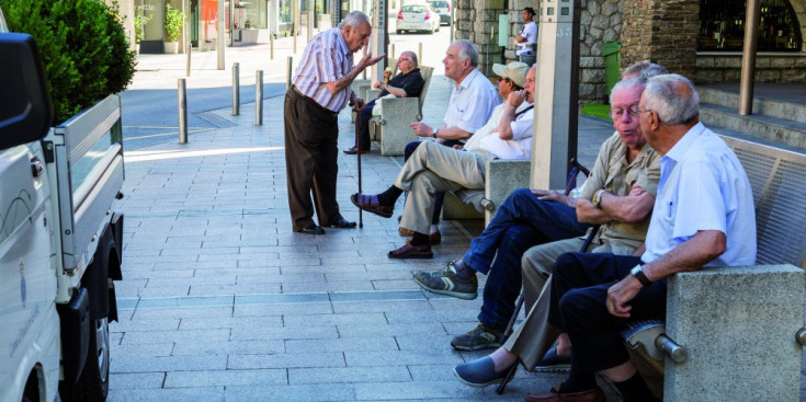 Uns jubilats asseguts a uns bancs del carrer.