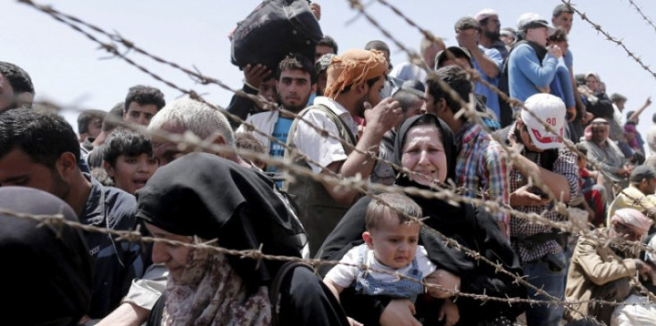 Refugiats sirians a la frontera turca.