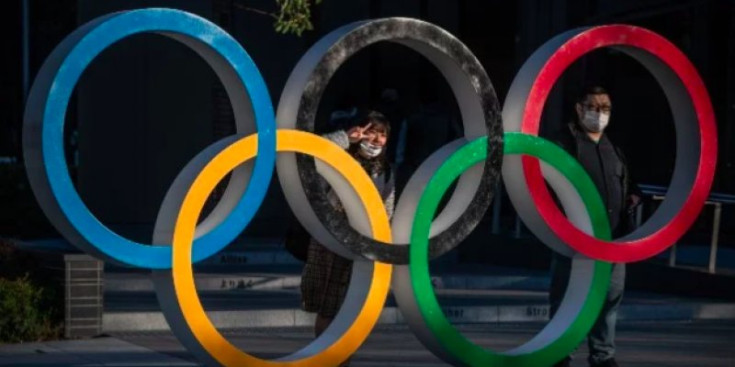Dos vianants es fan fotos amb el símbol dels Jocs Olímpics a Tòquio, aquest any.