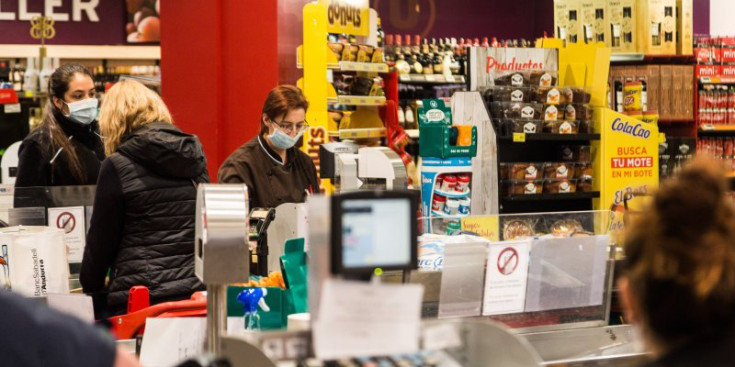 Persones amb mascareta dins un supermercat del país.