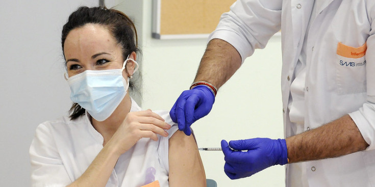 Una infermera rep la primera dosi de la vacuna