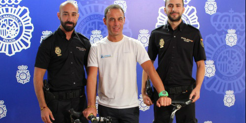 Els dos agents de la Policia Nacional espanyola i el representant d’Orica, a l’entrega de la bici robada.