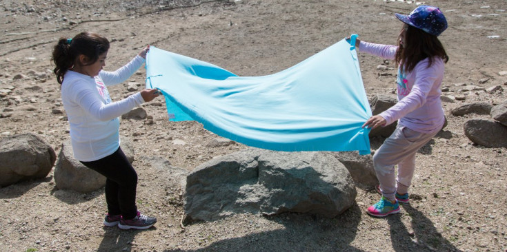 Dues nenes practiquen ‘land art’ al llac d’Engolasters.