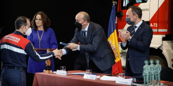 El ministre d’Interior, Josep Maria Rossell, entrega un reconeixement a un bomber.