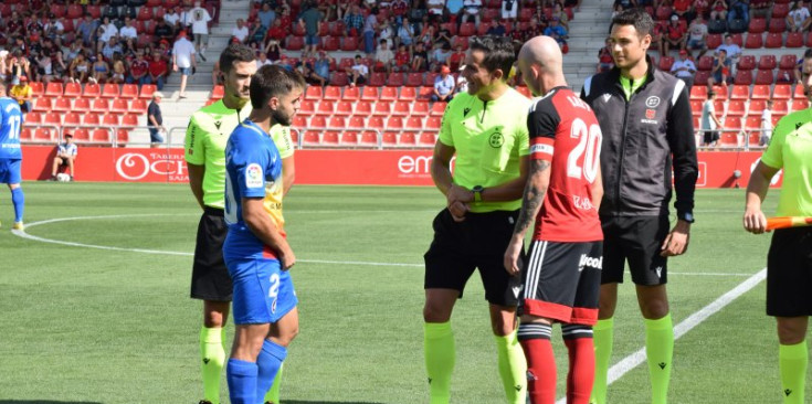 L’àbritre principal del partit entre el CD Mirandés i l’FC Andorra conversa amb el capità tricolor, Martí Vilà.