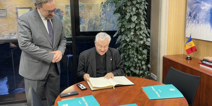 Moment previ a la dedicatòria del copríncep episcopal, Joan-Enric Vives, en el llibre d'honor de la Universitat d'Andorra.